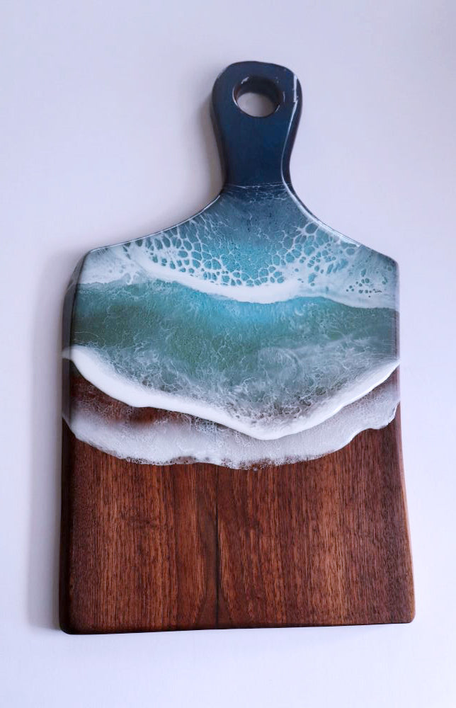 Black walnut ocean resin cutting board with blue and white wave design