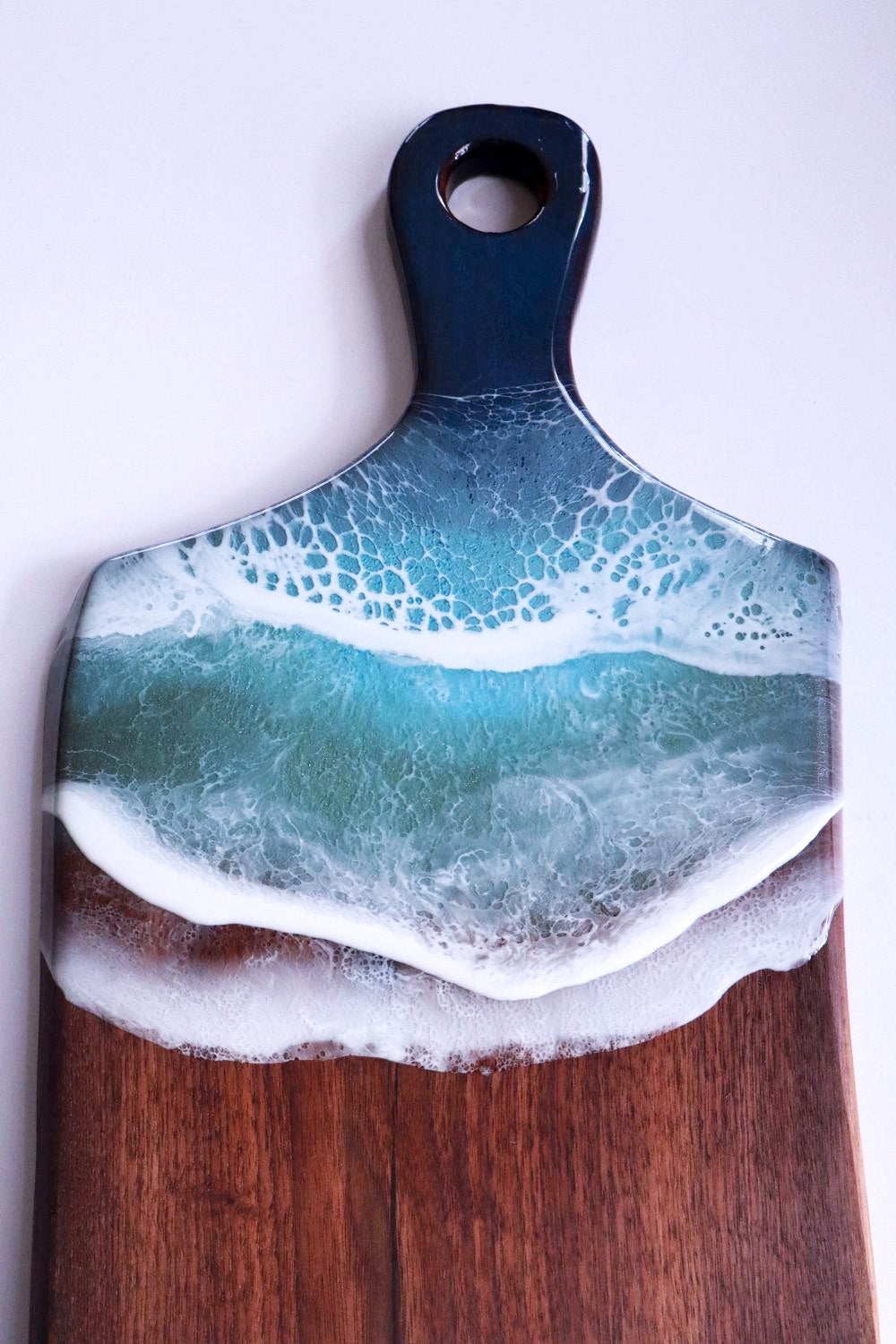 Close-up of ocean resin waves on handmade cutting board